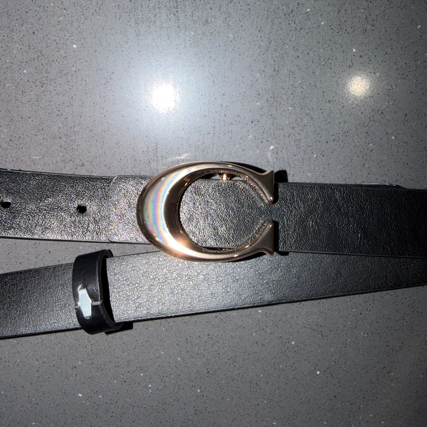 Belt with letter C on it